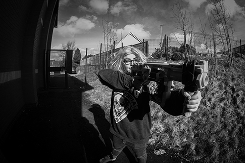 LOCWS Creative Participation Programme Featuring Young Woman Holding Toy Gun from Communities First East Cluster's Film-Making Course at Birchgrove Community Centre